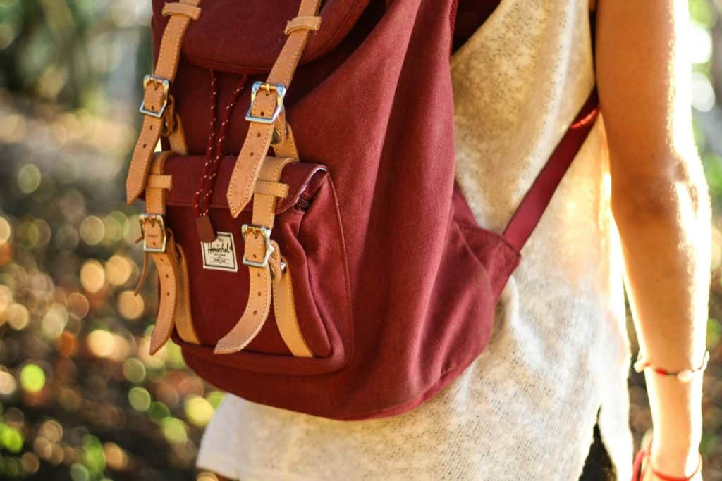 person with red rucksack - back-to-school energy protection is important