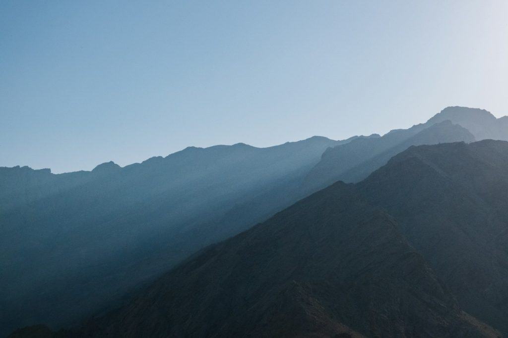 a view of a mountain range from a distance, representing spiritual energy clearing - the clear skies