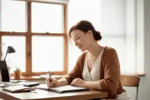 Woman working at a desk.